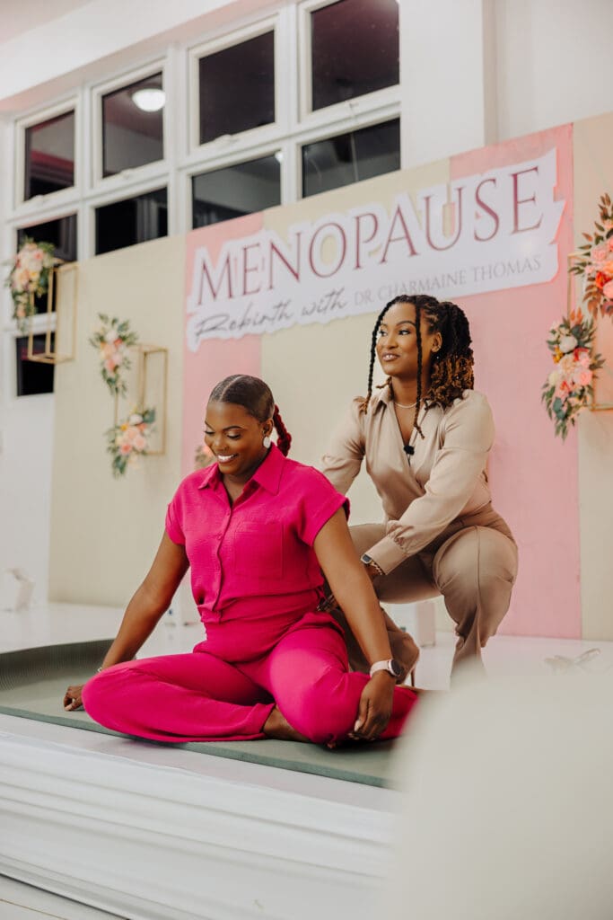 Physiotherapist Natalia Fennell guiding a woman through a stretching exercise during the Menopause Rebirth Podcast workshop, highlighting practical solutions for menopause tightness.